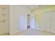 Carpeted bedroom featuring closet and doorway, with wall decorations, creating a cozy and inviting atmosphere at 8213 Swann Hollow Dr, Tampa, FL 33647