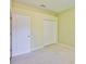 Carpeted bedroom featuring closet and doorway, providing a comfortable and versatile living space at 8213 Swann Hollow Dr, Tampa, FL 33647