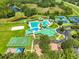 Great overhead shot of the community pool and recreational areas with a pond nearby at 8213 Swann Hollow Dr, Tampa, FL 33647