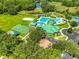 Overhead shot of the community pool with beach volleyball, basketball, and playset at 8213 Swann Hollow Dr, Tampa, FL 33647