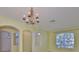 Elegant dining room area showcasing archways, a chandelier, and large windows at 8213 Swann Hollow Dr, Tampa, FL 33647