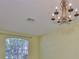 Dining room with decorative chandelier, arched doorway, and large window at 8213 Swann Hollow Dr, Tampa, FL 33647