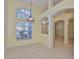 Open dining space with tile floors, high ceilings, a large window, and arched doorways at 8213 Swann Hollow Dr, Tampa, FL 33647