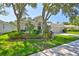 Inviting single-story home with a verdant lawn, mature trees, and a practical two-car garage at 8213 Swann Hollow Dr, Tampa, FL 33647