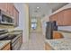 Bright kitchen with stainless appliances, granite countertops, and tile flooring at 8213 Swann Hollow Dr, Tampa, FL 33647