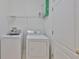 Clean laundry room with washer, dryer, shelf, and tile flooring at 8213 Swann Hollow Dr, Tampa, FL 33647