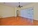 Spacious living room with wood floors, a ceiling fan, and natural light from the sliding glass door at 8213 Swann Hollow Dr, Tampa, FL 33647