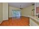Living room featuring wood floors, a ceiling fan, and a sliding glass door to the outside at 8213 Swann Hollow Dr, Tampa, FL 33647