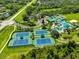 Aerial shot of community tennis and pickle ball courts with the pool nearby at 8213 Swann Hollow Dr, Tampa, FL 33647