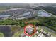 An aerial view of the home highlighting its location in a desirable community with lakes at 8515 Hunters Fork Loop, Ruskin, FL 33573