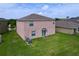 Aerial view of the backyard with a grassy lawn and two A/C units at 8515 Hunters Fork Loop, Ruskin, FL 33573