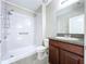 Bathroom with a single sink vanity, granite countertop, and a tub/shower combo at 8515 Hunters Fork Loop, Ruskin, FL 33573