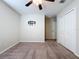 Standard bedroom with neutral carpeting, a ceiling fan, and a closet at 8515 Hunters Fork Loop, Ruskin, FL 33573