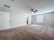 Large carpeted bedroom featuring a ceiling fan, natural light, and a spacious closet at 8515 Hunters Fork Loop, Ruskin, FL 33573
