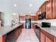 Well-equipped kitchen featuring granite countertops, dark cabinetry, and modern appliances at 8515 Hunters Fork Loop, Ruskin, FL 33573