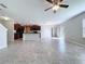 Open-concept kitchen with dark wood cabinets, tile floors, and ample natural light at 8515 Hunters Fork Loop, Ruskin, FL 33573