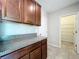 Close-up of kitchen cabinets and pantry featuring granite countertops and ample storage space at 8515 Hunters Fork Loop, Ruskin, FL 33573