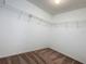 Spacious walk-in closet featuring carpeted floors and white walls with metal shelving for organized storage at 8515 Hunters Fork Loop, Ruskin, FL 33573