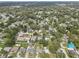Aerial view showcases a residential neighborhood, highlighting mature trees and a mix of home designs at 8701 N Packwood Ave, Tampa, FL 33604