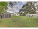 This spacious backyard includes multiple storage buildings and open space at 8701 N Packwood Ave, Tampa, FL 33604