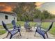 Enjoy a relaxing day on the backyard patio with comfortable blue seating and a fire pit at 8701 N Packwood Ave, Tampa, FL 33604