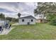 This backyard features a storage shed, mature tree, and cozy seating at 8701 N Packwood Ave, Tampa, FL 33604