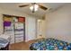 This bedroom features wood-look floors, fan and closet with built-ins for ample storage at 8701 N Packwood Ave, Tampa, FL 33604