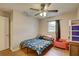 Bedroom featuring wood-look floors, a ceiling fan, and natural light at 8701 N Packwood Ave, Tampa, FL 33604