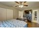 Bedroom featuring wood-look floors and a view into an organized closet at 8701 N Packwood Ave, Tampa, FL 33604