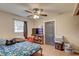 Comfortable bedroom featuring a ceiling fan and wood-look floors at 8701 N Packwood Ave, Tampa, FL 33604