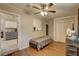 Bedroom featuring wood-look floors, a ceiling fan, and bright natural light at 8701 N Packwood Ave, Tampa, FL 33604