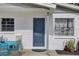 Close-up of the front door with a small outdoor seating area at 8701 N Packwood Ave, Tampa, FL 33604