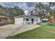 Single-story home with a well-kept lawn and a play set at 8701 N Packwood Ave, Tampa, FL 33604