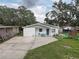 Single-story home with a well-kept lawn and a play set at 8701 N Packwood Ave, Tampa, FL 33604