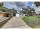 Home with a well-kept lawn and a play set and a long driveway at 8701 N Packwood Ave, Tampa, FL 33604
