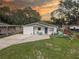 Charming single-story home featuring a manicured lawn and outdoor play area at 8701 N Packwood Ave, Tampa, FL 33604