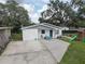 Single-story home with a well-kept lawn and a play set at 8701 N Packwood Ave, Tampa, FL 33604