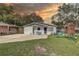 Charming single-story home featuring a manicured lawn and outdoor play area at 8701 N Packwood Ave, Tampa, FL 33604