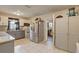 Kitchen featuring tile flooring, granite counters, stainless appliances, and white and grey cabinets at 8701 N Packwood Ave, Tampa, FL 33604