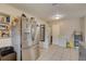 View of the kitchen featuring stainless steel appliances, tile flooring and a pantry at 8701 N Packwood Ave, Tampa, FL 33604