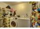 This laundry room features a washer, dryer and storage shelves at 8701 N Packwood Ave, Tampa, FL 33604