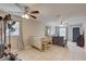 Bright living room with tile floors, a dining room and a ceiling fan at 8701 N Packwood Ave, Tampa, FL 33604