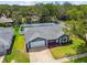 Aerial view of a home featuring a well-maintained lawn and mature trees at 8823 Aruba Ln, Port Richey, FL 34668