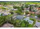 Residential neighborhood view with mature trees surrounding the listing, which has a patio and privacy fence at 8823 Aruba Ln, Port Richey, FL 34668