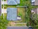 Aerial view of backyard with patio, a gravel walkway, and privacy fence at 8823 Aruba Ln, Port Richey, FL 34668