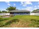 Well-maintained backyard featuring a charming brick fire pit and a white privacy fence at 8823 Aruba Ln, Port Richey, FL 34668