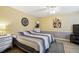 Spacious bedroom featuring neutral tones, tile flooring, and a decorative wall hanging at 8823 Aruba Ln, Port Richey, FL 34668