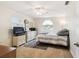 Neutral bedroom offers a ceiling fan, a dresser and a window with natural light at 8823 Aruba Ln, Port Richey, FL 34668
