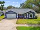 Charming single-story home featuring a two-car garage and well-manicured front yard at 8823 Aruba Ln, Port Richey, FL 34668