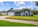 Attractive single-story home boasting a manicured lawn, a blue exterior and a convenient two-car garage at 8823 Aruba Ln, Port Richey, FL 34668
